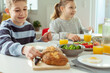 Teen children having healthy breakfast at home before school