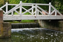 Beautiful View Of A Small White Bridge Over The Stream In A Park In Schwetzingen, Germany
