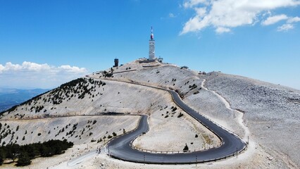 Poster - Narrow highway leading to the Mont Ventoux in France with a blue sky in the background