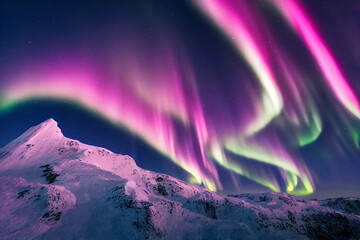 Wall Mural - northern lights over snowy mountains. aurora borealis with starry in the night sky. fantastic winter