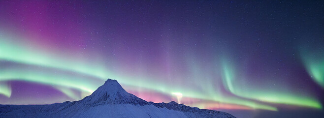northern lights over snowy mountains. aurora borealis with starry in the night sky. fantastic winter