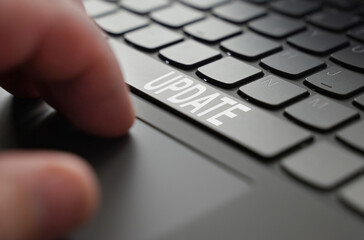 Poster - On the laptop keyboard of a person's hand, on the space bar there is an inscription - Update