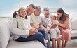 © L Ismail/peopleimages.com - Family, children and love with a girl her father bonding together at home with their relatives in the living room. Kids, parents and grandparents sitting on a sofa in their house during a visit