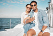© C Daniels/peopleimages.com - Happy couple on yacht with champagne smile and celebrate love with romantic tropical holiday travel on ocean. Dating man and woman on luxury boat on beach water or sea with wine glass for celebration