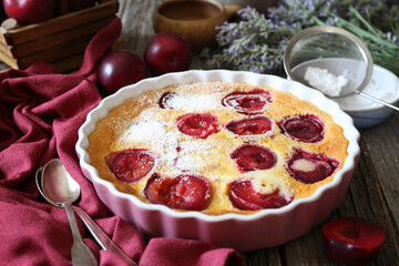 Wall Mural - Red plums clafoutis (flan), icing sugar dressing, french cuisine