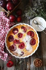 Wall Mural - Red plums clafoutis (flan), icing sugar dressing, french cuisine