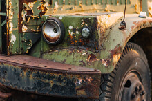 Headlight Front Of An Old, Rusty, Abandoned, Military, Truck Car With Cracked Paint. Photo Of The Vehicle.