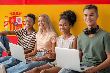 Canvas Print - Students with modern devices against flag of Spain