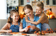 © JenkoAtaman - Young family mother  and children preparing decorations for Halloween