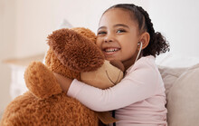 Children, Teddy Bear And Girl With A Child Hugging Her Stuffed Animal With A Smile In Her House. Kids, Happy And Safe With An Adorable Or Cute Female Kid Holding A Fluffy Toy While Sitting On A Bed