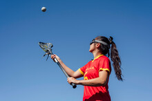 Athlete Playing Lacrosse Under Blue Sky