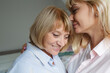 © Westend61 - Happy daughter embracing and caring mother at home