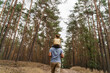© Westend61 - Mature man carrying girl on shoulders and hiking in forest