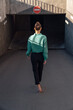 © Westend61 - Businesswoman walking toward parking garage entrance on sunny day