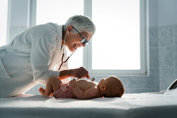 Pediatrician examining little baby to prevent diseases