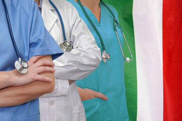 Wall Mural - Three Doctors with stethoscope in standing on Italy flag background. Close-up medical team. Group of doctors and nurses. Innovative technologies in science and medicine, medical development in Italy