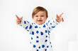 © Lisa Tichané - Baby wearing pajamas with printed blue hearts making funny move