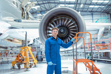Portrait Of Apprentice Aircraft Maintenance Engineer In Maintenance Hangar