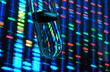 © Connect Images - Test tube with illuminated genetic data in background