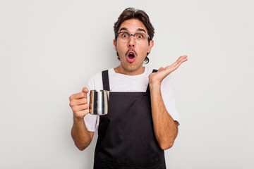 Wall Mural - Young hispanic barista man isolated on white background surprised and shocked.