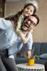 Father and daughter playing in living room