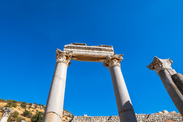 Wall Mural - columns of Ephesus building or gate at Ephesus ancient city archeological site in Turkey. Ephesus is a UNESCO World Heritage site.