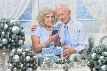 Canvas Print - Elderly couple in a room with New Year's decor