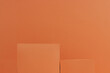empty two square podium for design, product on orange background. 