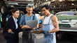 © NVB Stocker - Asian young woman customer talking with owner and mechanic worker at car repair service and auto store shop.
