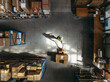 © Jacob Lund - Aerial view of a warehouse employee puling a pallet truck