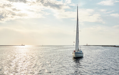 Poster - White sloop rigged yacht sailing in the Baltic sea on a clear day. Transportation, cruise, yachting, regatta, sport, recreation themes. Travel, exploring, wanderlust concepts