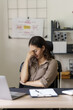© NanSan - Depressed tired asian businesswoman, stressed at office workplace.