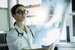 © khwanchai - Female doctor check on scan results on monitors in laboratory
