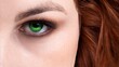 Beautiful green eye of the red-haired woman, close up, selected focus.
