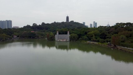 Canvas Print - Drone view, evening time flight over Foshan city famous Lakeside downtown park, Qiandeng Lake, China