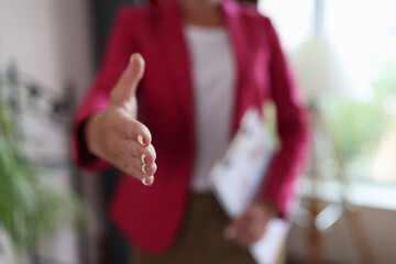 Wall Mural - Closeup of woman hand reaching out for greeting in office