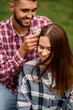 © fesenko - close-up of woman whose man decorates her hair with flowers