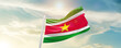 Suriname national flag cloth fabric waving on the sky - Image
