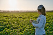 Smart farmer woman agronomist checks the field with tablet. Inteligent agriculture and digital agriculture..Female, young woman