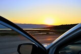 Fototapeta  - Piękny wschód słońca nad Morzem Adriatyckim, widziany oczami kierowcy, po dotarciu do celu podróży