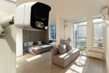 Close Up Object Shot of a Modern Wi-Fi Surveillance Camera on a White Wall in a Cozy Apartment Has Wi-Fi Icon Above it.