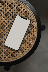 Flatlay phone on rattan table. Aesthetic elegant blog, online shop, store social media template