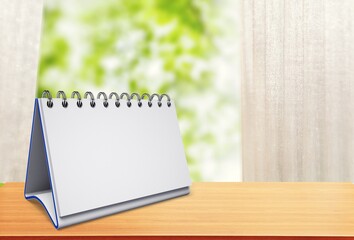 Wall Mural - Blank empty planner on the desk with trees background