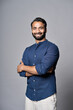 Smiling bearded indian business man investor, happy ethnic ceo, corporate executive, professional lawyer, successful rich banker, male office employee or salesman isolated on gray, vertical portrait.