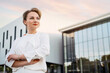 © Maria Vitkovska - Portrait of confident middle aged businesswoman with arms crossed wearing stylish clothing looking away, planning project, copy space. Successful business