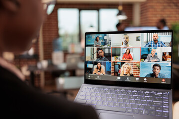 Wall Mural - Startup manager talking on online videocall conference with business people, using remote teleconference chat on internet meeting with webcam. Chatting on videoconference in company office.