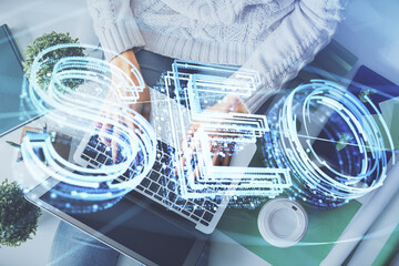 Poster - Double exposure of woman hands working on computer and SEO hologram drawing. Top View. Search optimization concept.