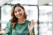 © Phushutter - Happy millennial asian woman wave talking and having conversation video call on laptop.
