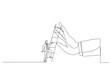 14 September 2022Illustration of ambitious businessman about to climb up ladder to overcome giant hand stopping him. Metaphor for overcome business obstacle, barrier or difficulty. One line art style