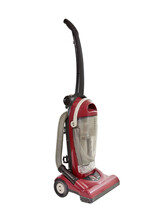 Old red vacuum cleaner isolated.